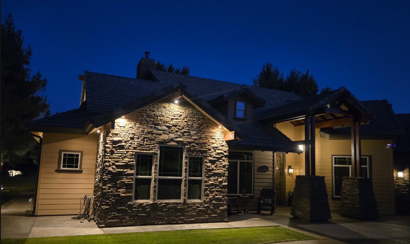 Landscape lighting illuminating a home and garden